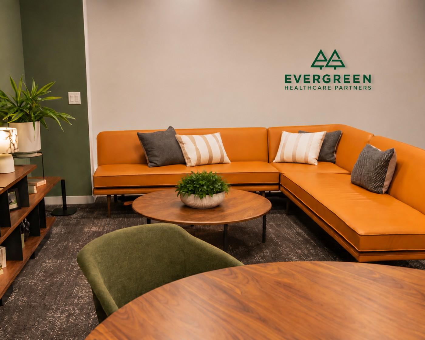 Evergreen Healthcare Partners office lounge with the logo on the wall